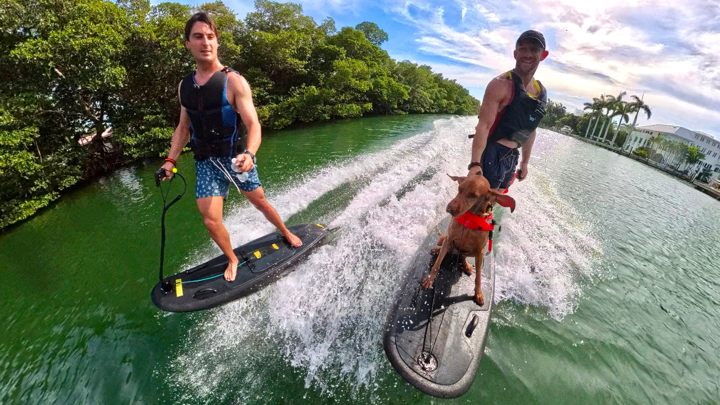 Friends riding Moovi electric surfboards together on Biscayne Bay