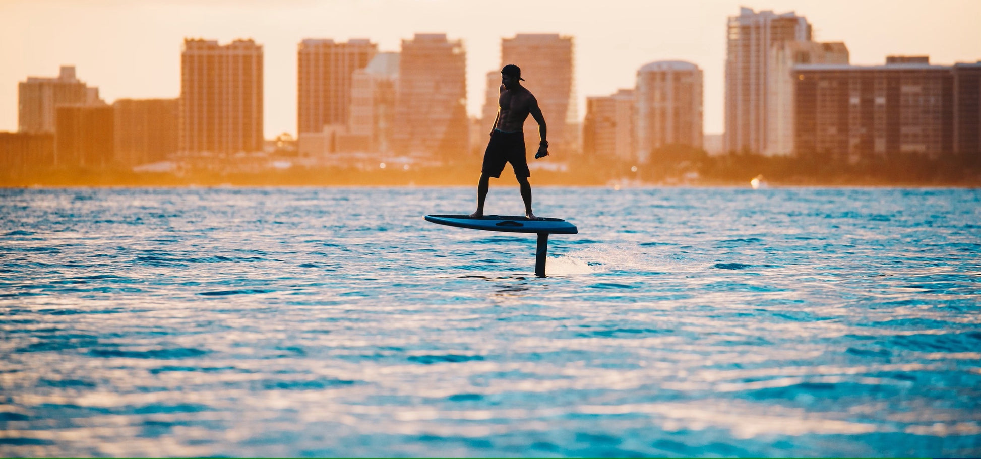 Man rides efoil past miami skyline