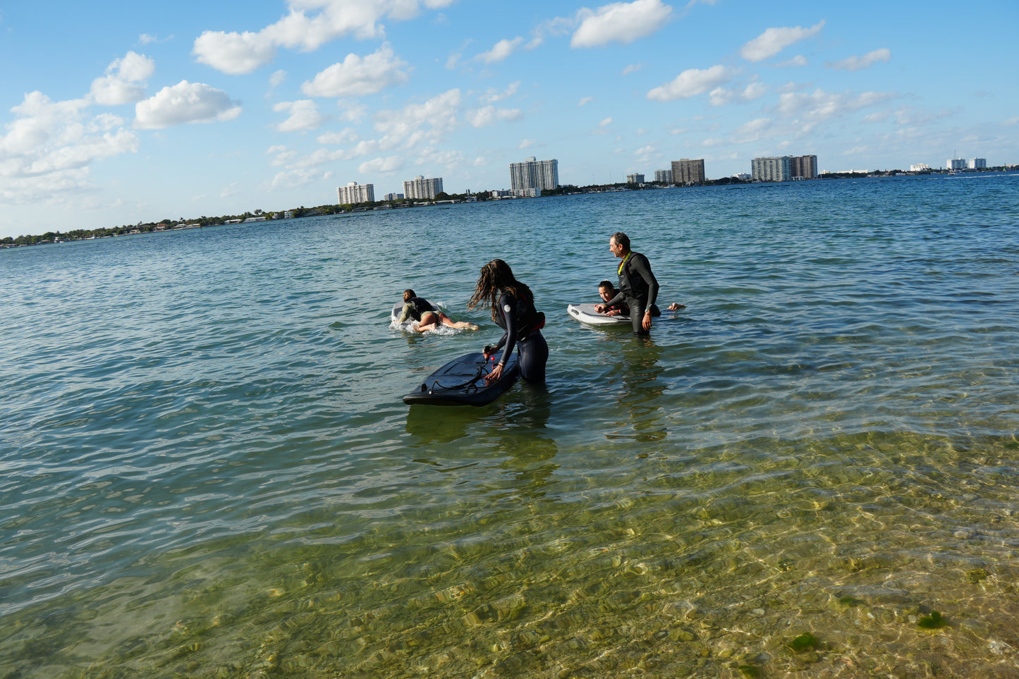Group electric surfboard lesson with two riders on Biscayne Bay