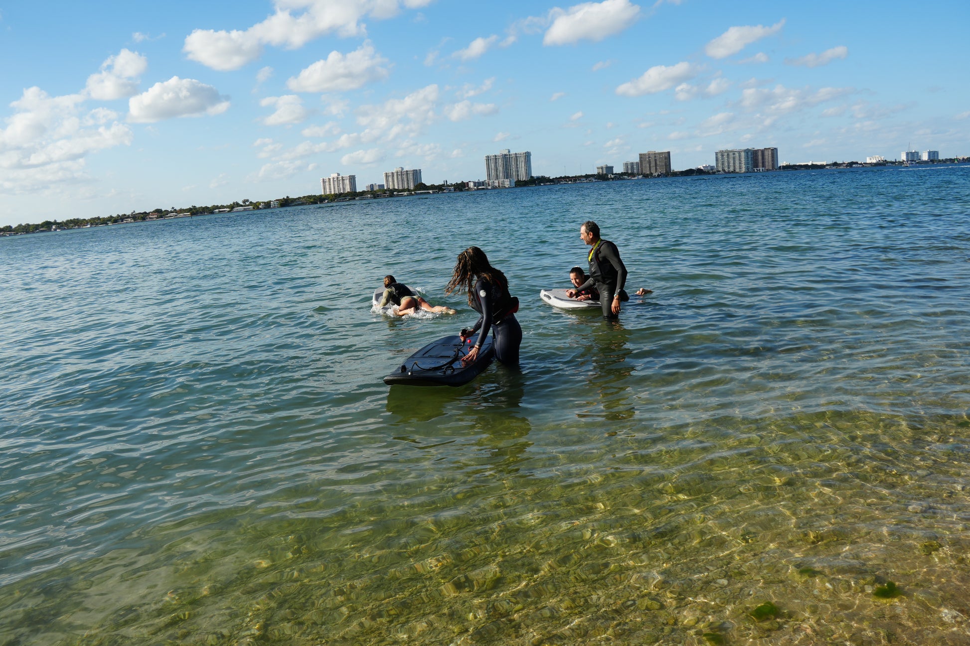 Group electric surfboard lesson with two riders on Biscayne Bay